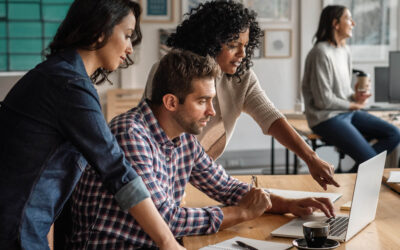 Forschungszulage für kleine und mittlere Unternehmen (KMU) ist die Drei junge Personen sitzen vor einem Laptop und besprechen etwas